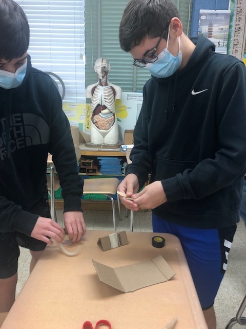 Tape and cardboard were two key components students could use to create their sled.